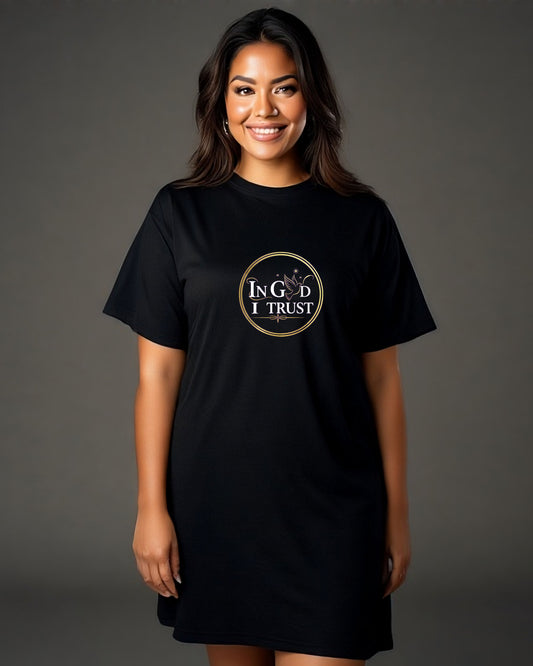 Woman wearing a black t-shirt with a gold logo and text , "In God I Trust", on a gray background