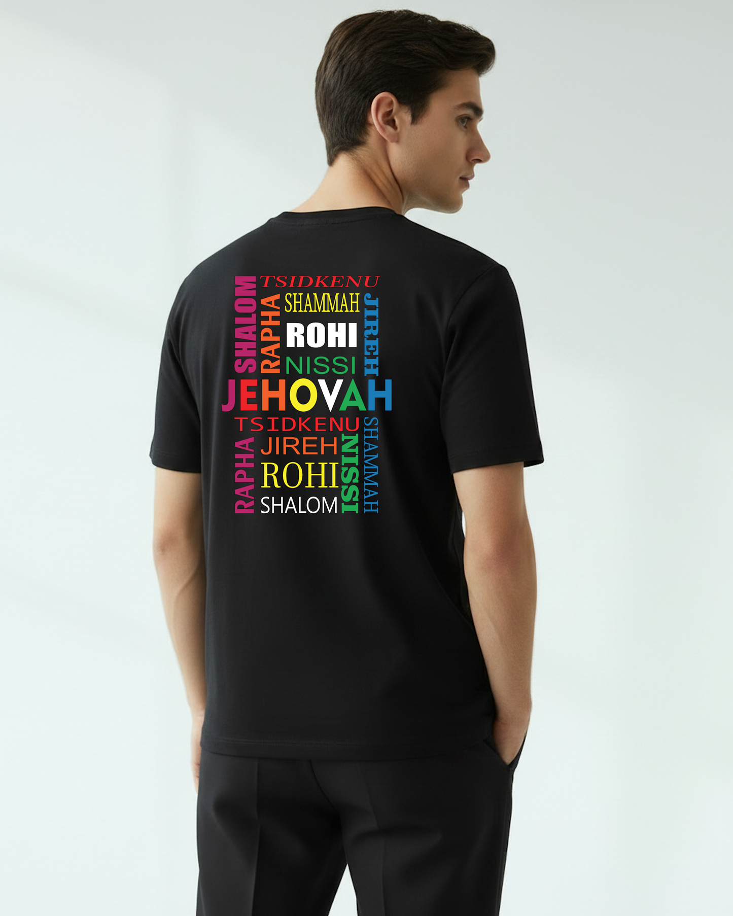 Man wearing a black t-shirt with colorful text printed on the back on a white background