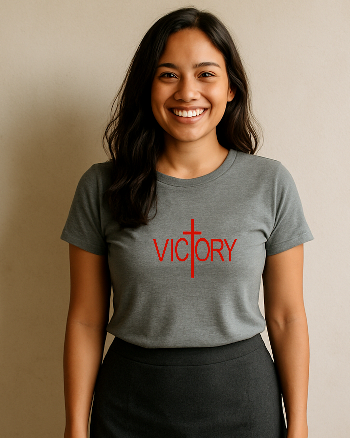 A woman wearing a grey t-shirt with a white Heavenly Dreamwear "Victory" logo printed on the front.