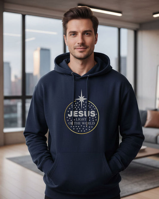 Man wearing a navy hoodie with 'Jesus Light of the World' design in a modern room.