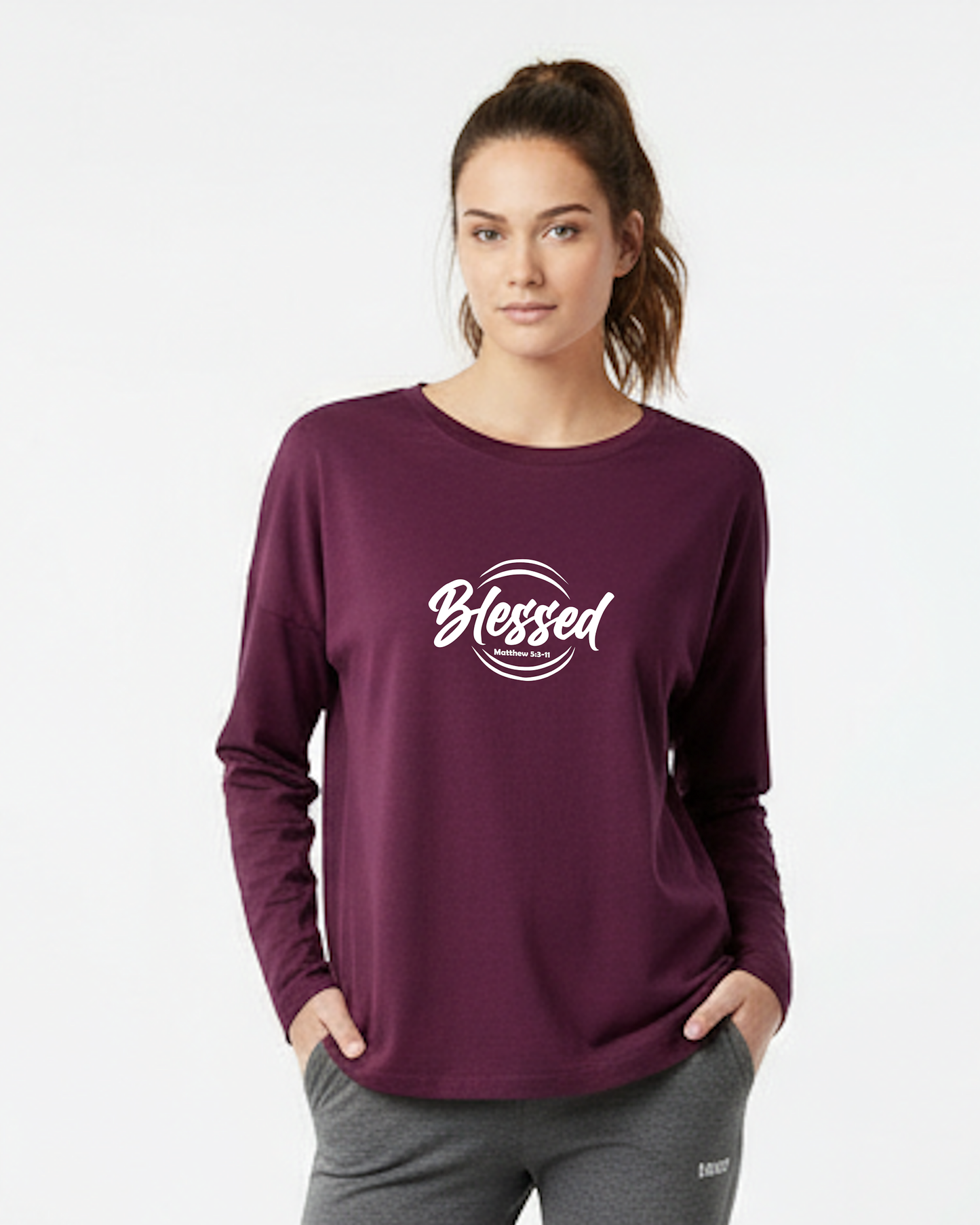 Woman wearing a purple long-sleeve shirt with white 'Blessed' text on a white background