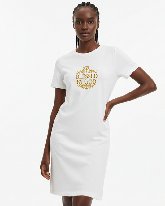 Woman wearing a white t-shirt dress with 'Blessed by God' text in gold, against a white background.