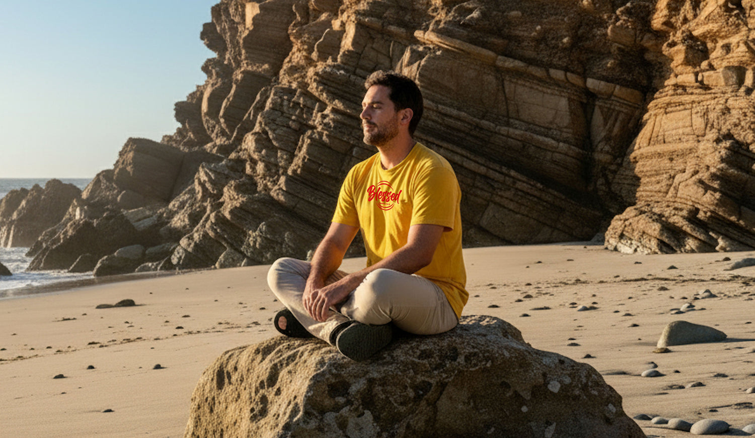 Man sitting on a rock in a deserted beach