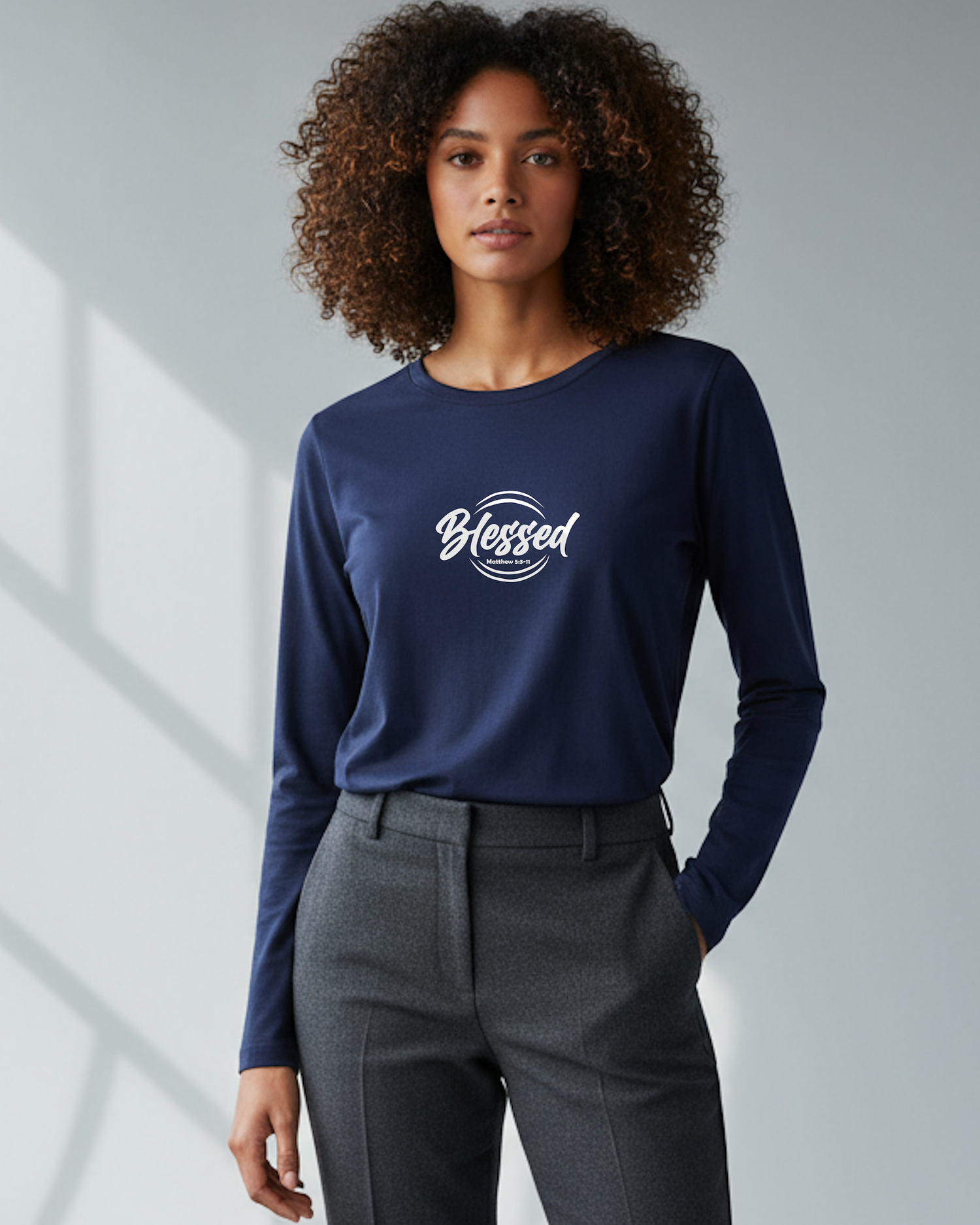 A man wearing a black long sleeve t-shirt with a "Faith Love Joy" logo