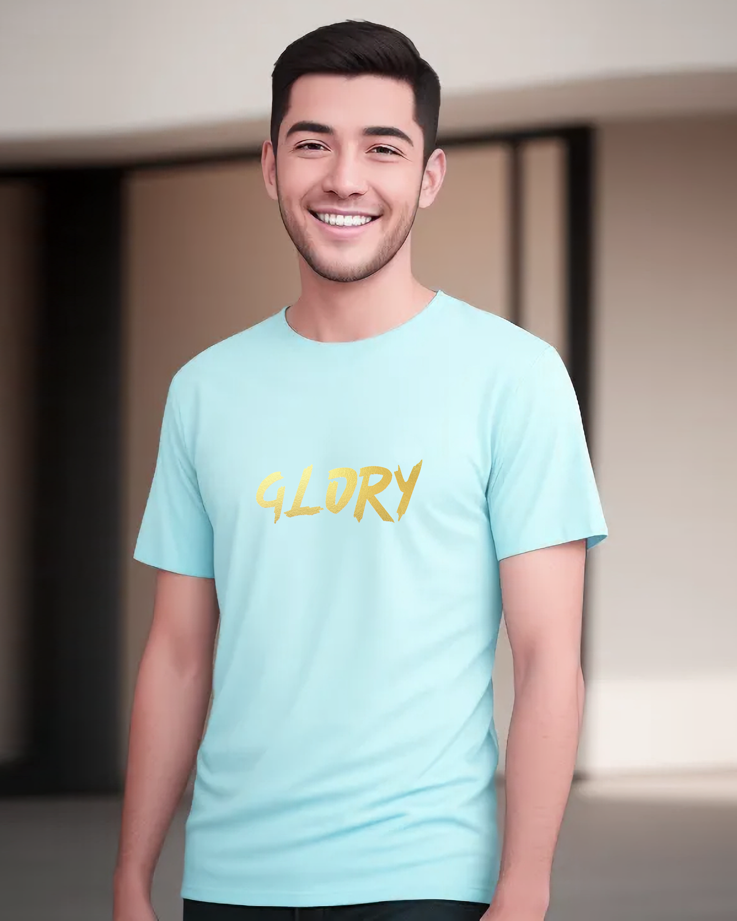 A man wearing an aquamarine t-shirt with a gold "Glory" text logo printed on the front.