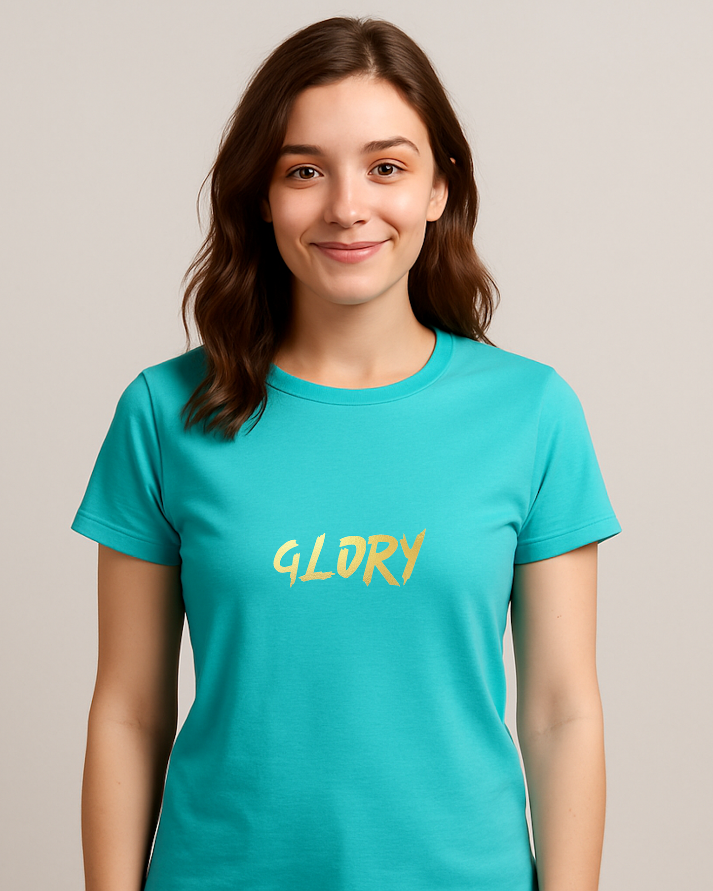 A woman wearing an aquamarine t-shirt with a gold "Glory" text logo printed on the front.