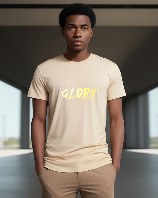 A man wearing a beige t-shirt with a gold "Glory" text logo printed on the front.