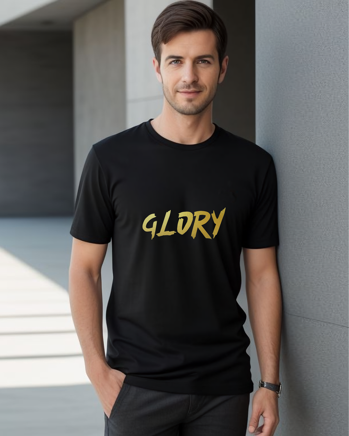 A man wearing a black t-shirt with a gold "Glory" text logo printed on the front.