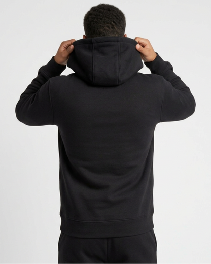 A man wearing a black hoodie viewed from the rear.