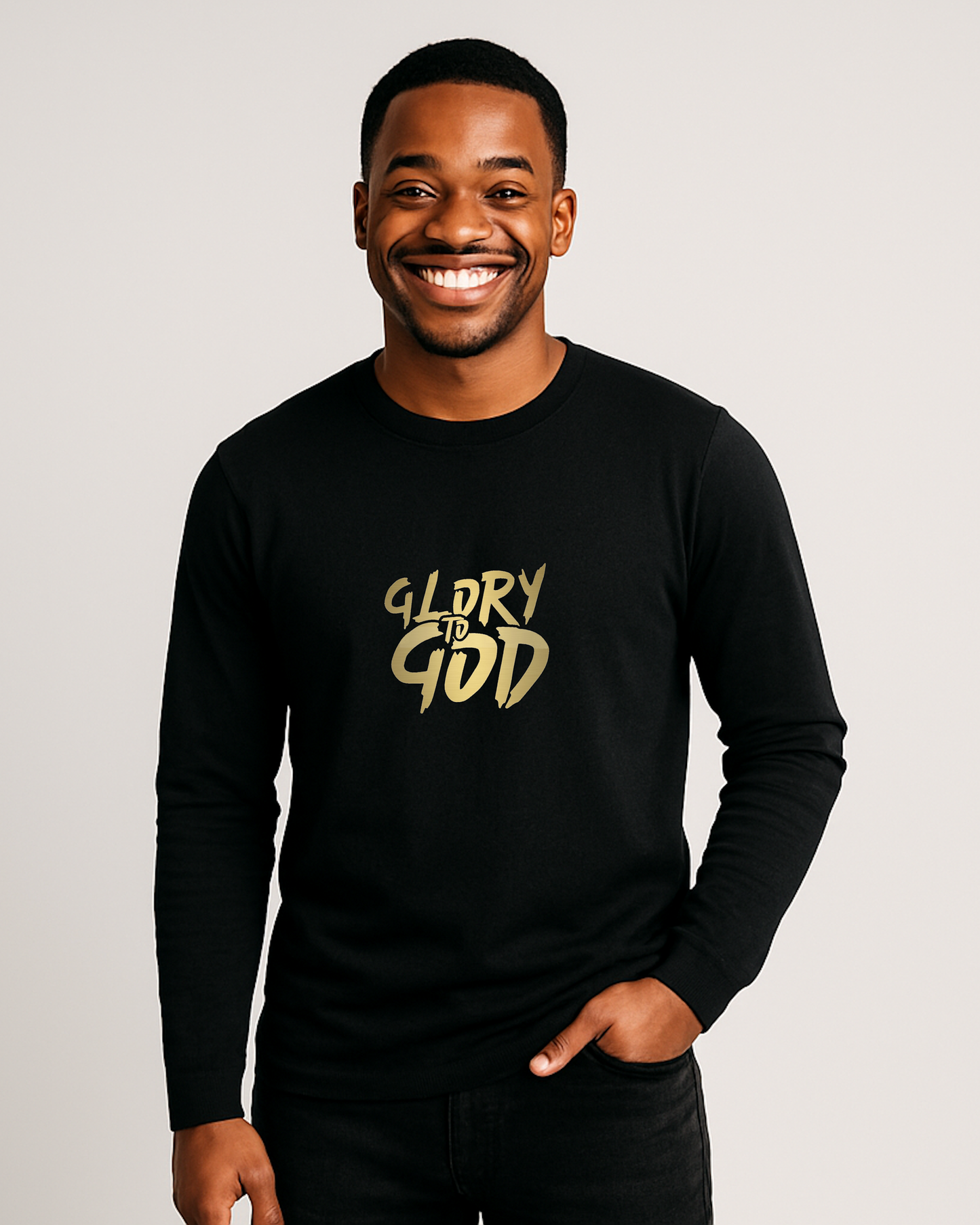A man wearing a black long sleeve shirt with 'Glory to God' text on a plain background