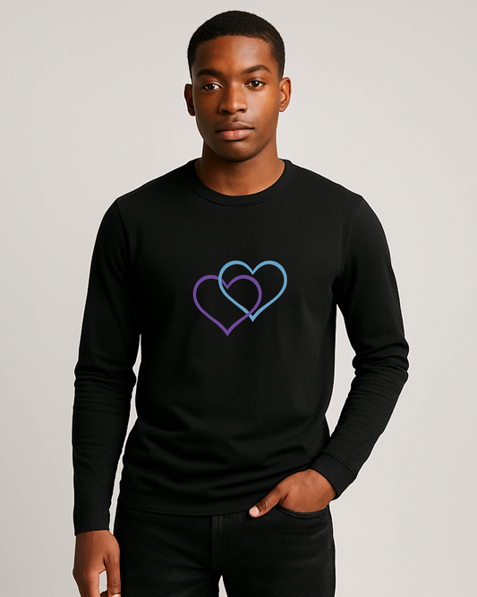 A man wearing a black long sleeve T-shirt with a dual inter-twinned heart design on a plain background
