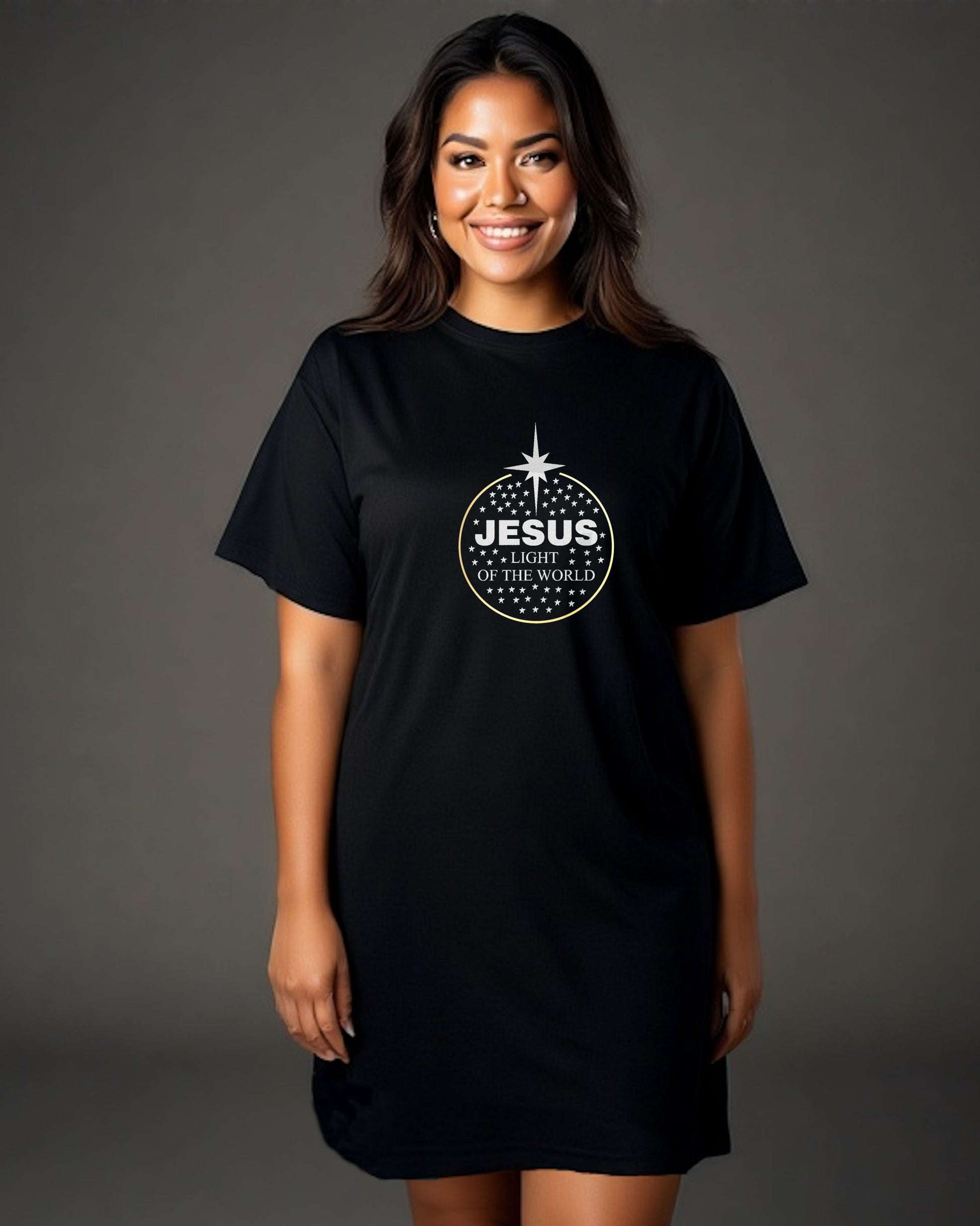 Woman wearing a black t-shirt dress with a logo made up of silver text, 'Jesus Light of the World', silver stars, and a gold ring against a neutral background