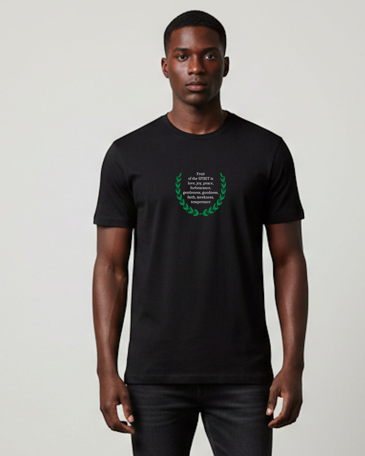 Man wearing a black t-shirt with a white text and green laurel wreath design against a white background.