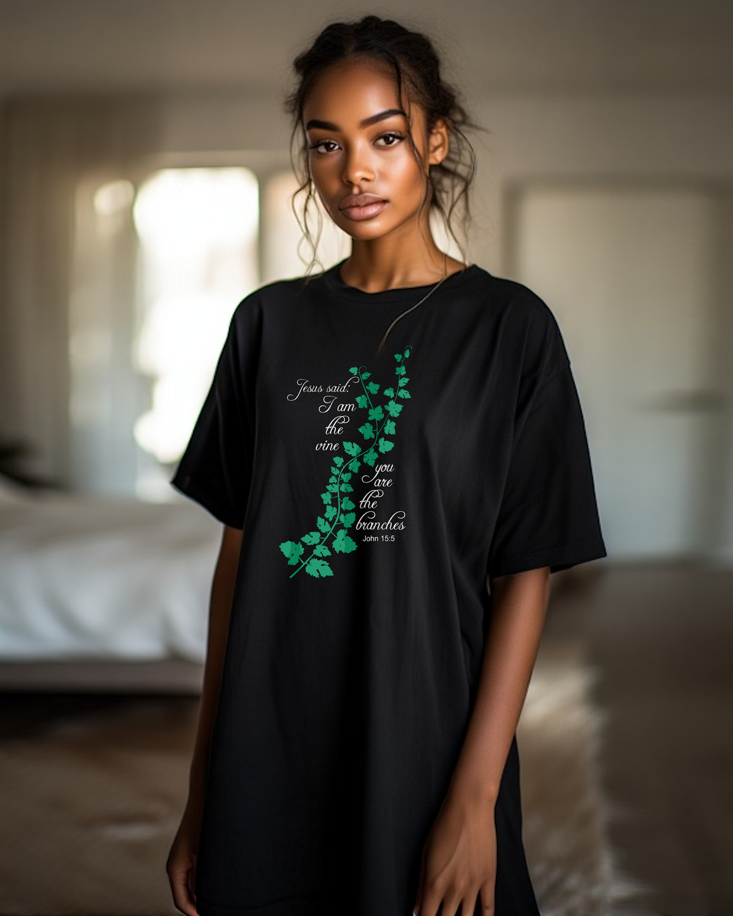 Woman wearing a black t-shirt dress with an elaborate green vine branch with the text, "Jesus said: I am the vine you are the branches" printed in white text on either side.