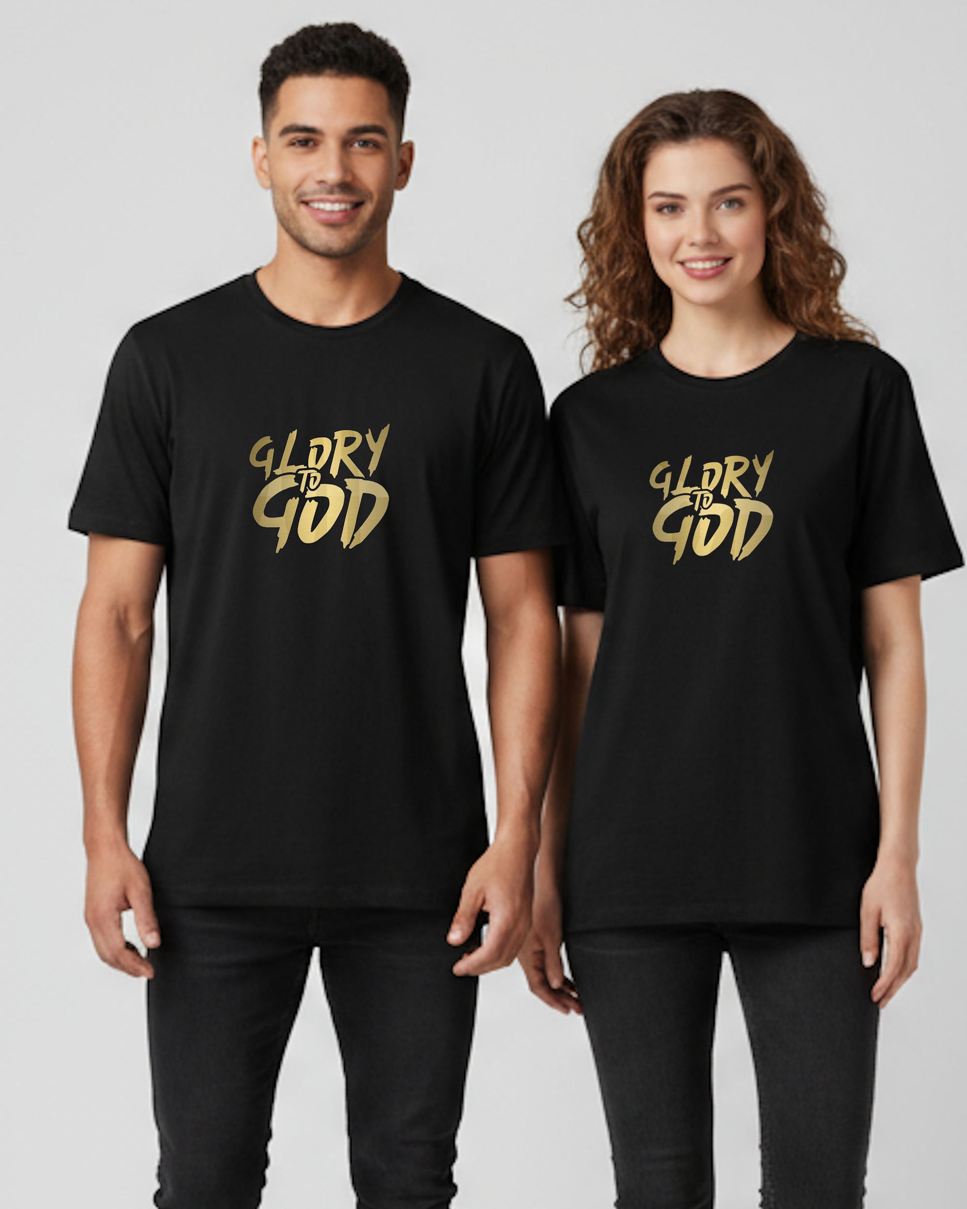 Two people wearing black t-shirts with 'GLORY TO GOD' in gold on a plain background