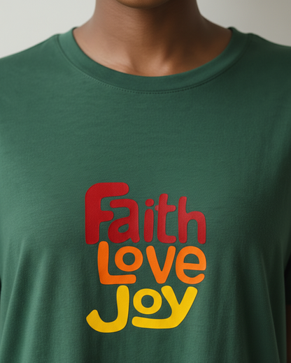 Closeup of the neck line of a green t-shirt dress with 'Faith Love Joy' text in red, orange, and yellow.