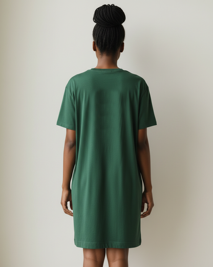 Side view of a woman wearing dark green t-shirt dress against a beige background.