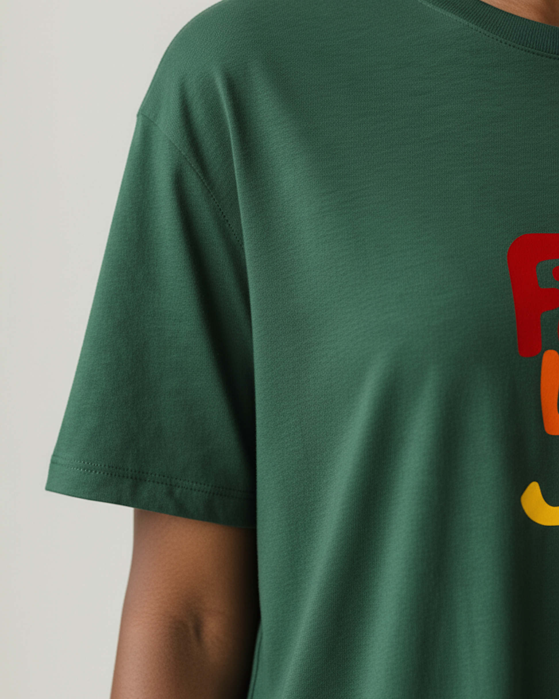 Closeup of the sleeve of a dark green t-shirt dress.