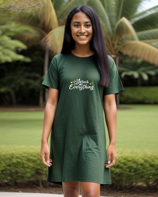 Woman wearing a dark green Heavenly Dreamwear t-shirt dress in a garden with a white text logo "Jesus MY Everything" with 4 yellow hearts printed on the dress.