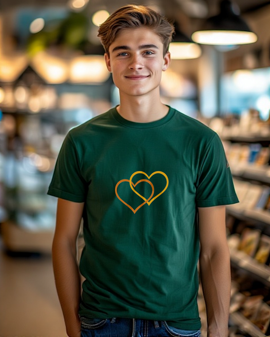 A man wearing a green t-shirt with a Heavenly Dreamwear logo comprised of an orange and yellow inter-twinned hearts.