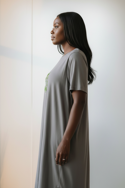 Side view of a woman wearing a grey t-shirt dress