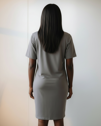 Woman wearing a gray t-shirt dress against a white background