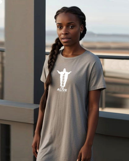 Woman on a balcony wearing a grey t-shirt dress with a white Jesus silhouette graphic and text.