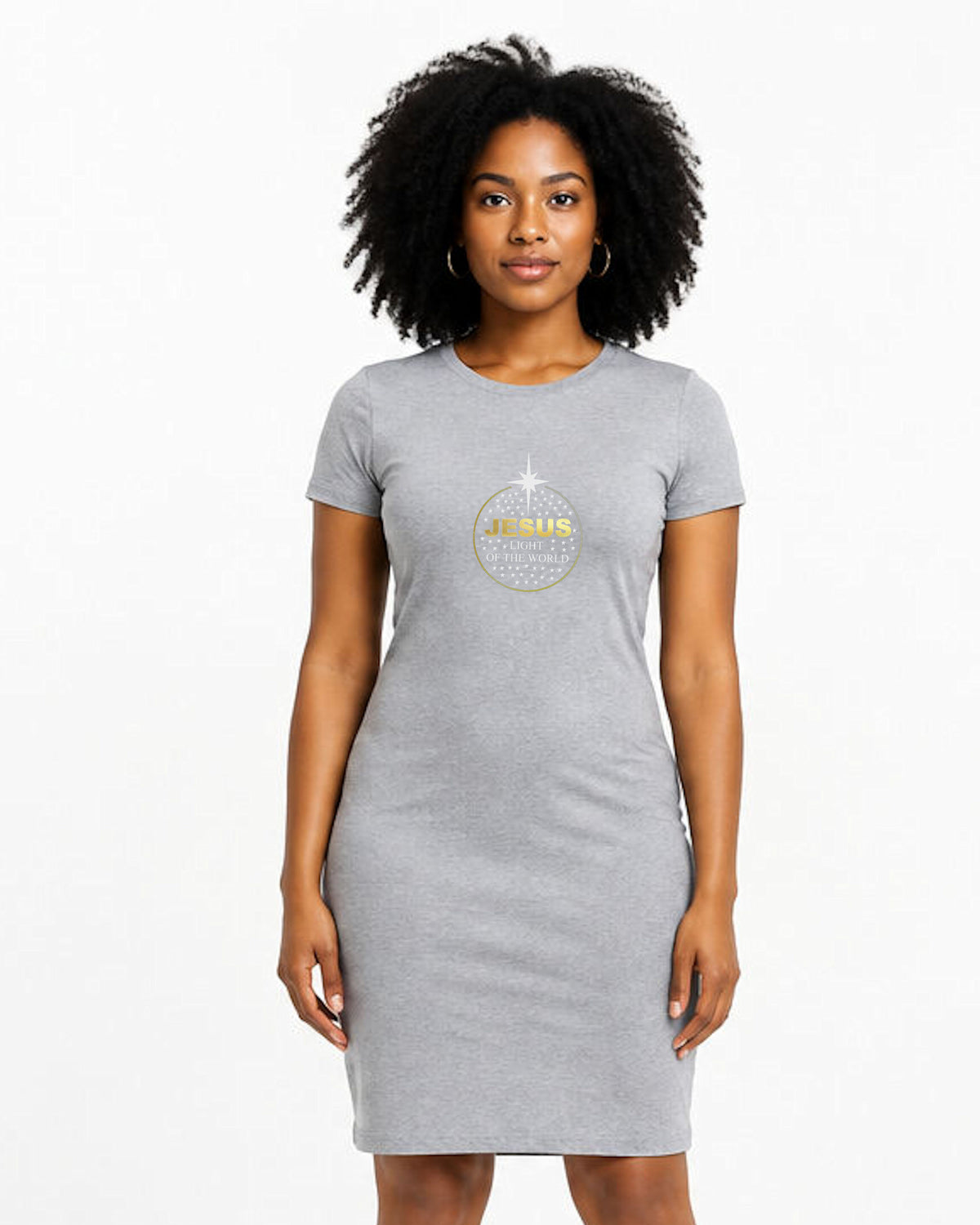 A woman modeling a light gray short-sleeve T-shirt dress with a gold and silver round ornament graphic on the chest that reads 'JESUS LIGHT OF THE WORLD'.