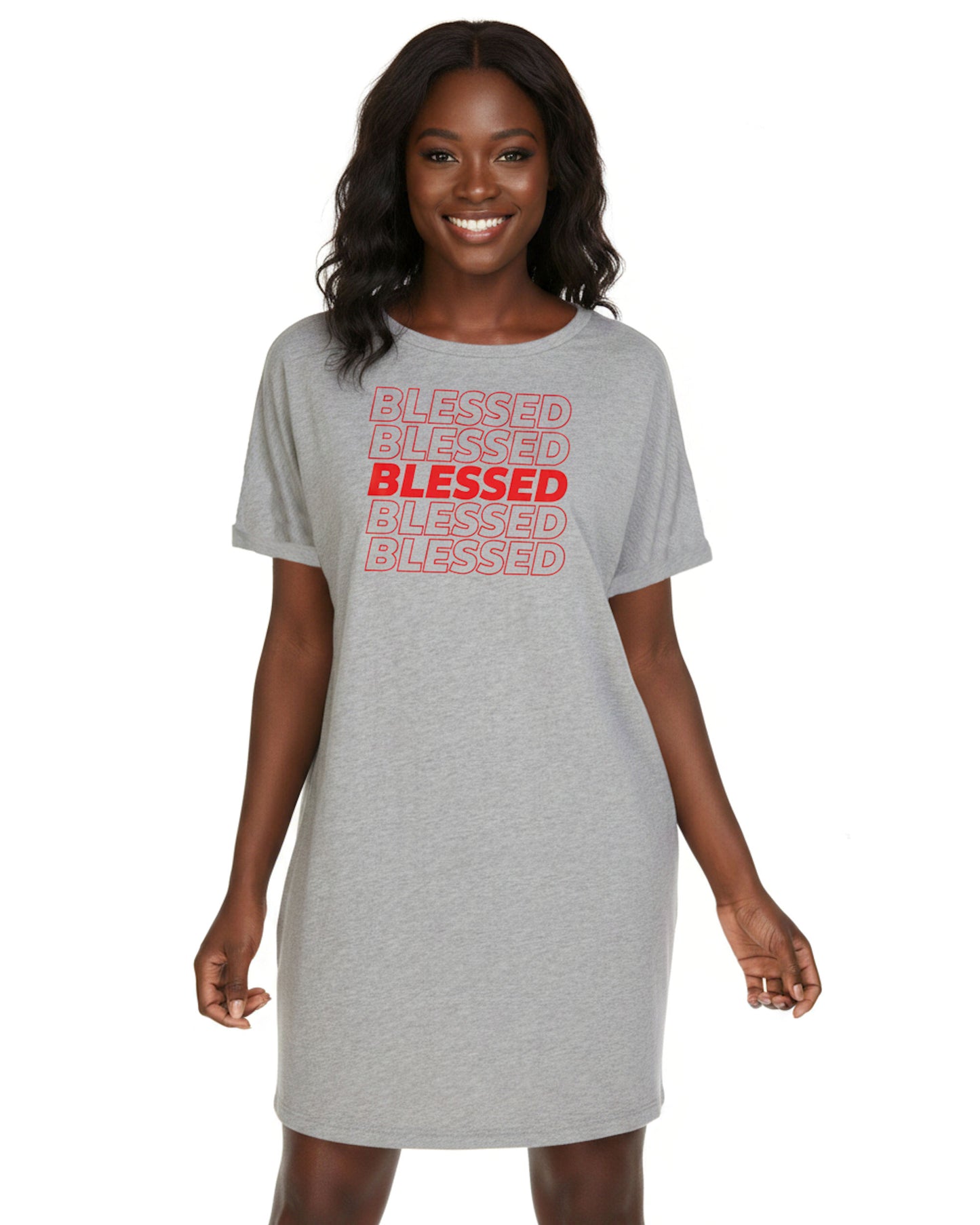 A woman modeling a light heather gray short-sleeve t-shirt dress with 'BLESSED' printed repeatedly in red and pink on the front, set against a plain white background.