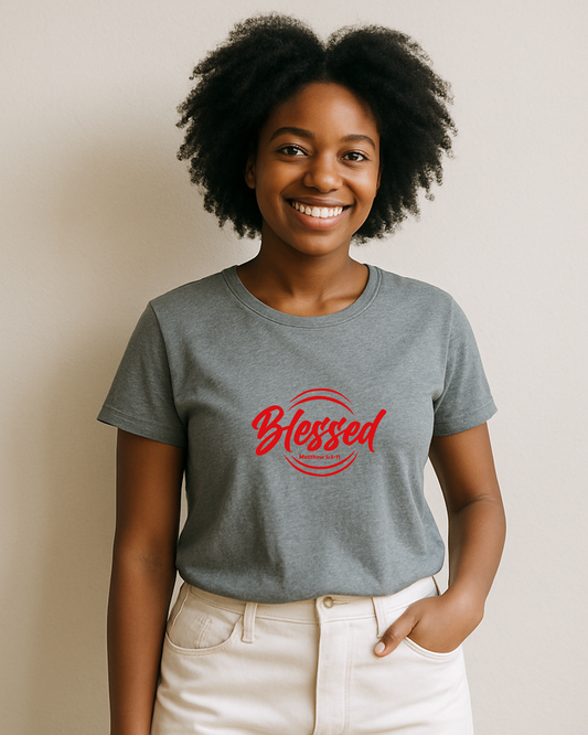 A young woman wearing a grey t-shirt with a white text logo that says 'Blessed' 