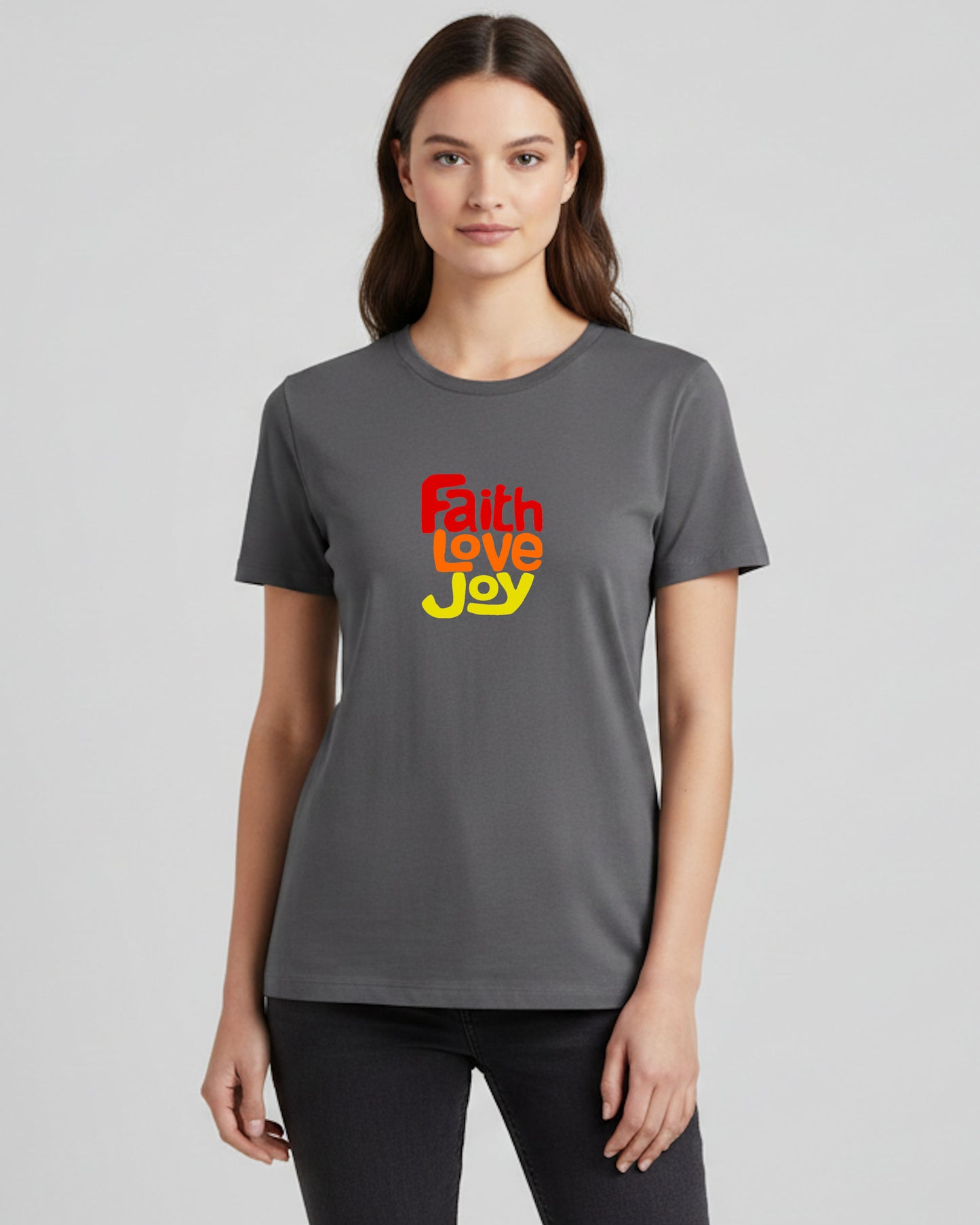 Woman wearing a gray t-shirt with 'Faith Love Joy' text on a plain background