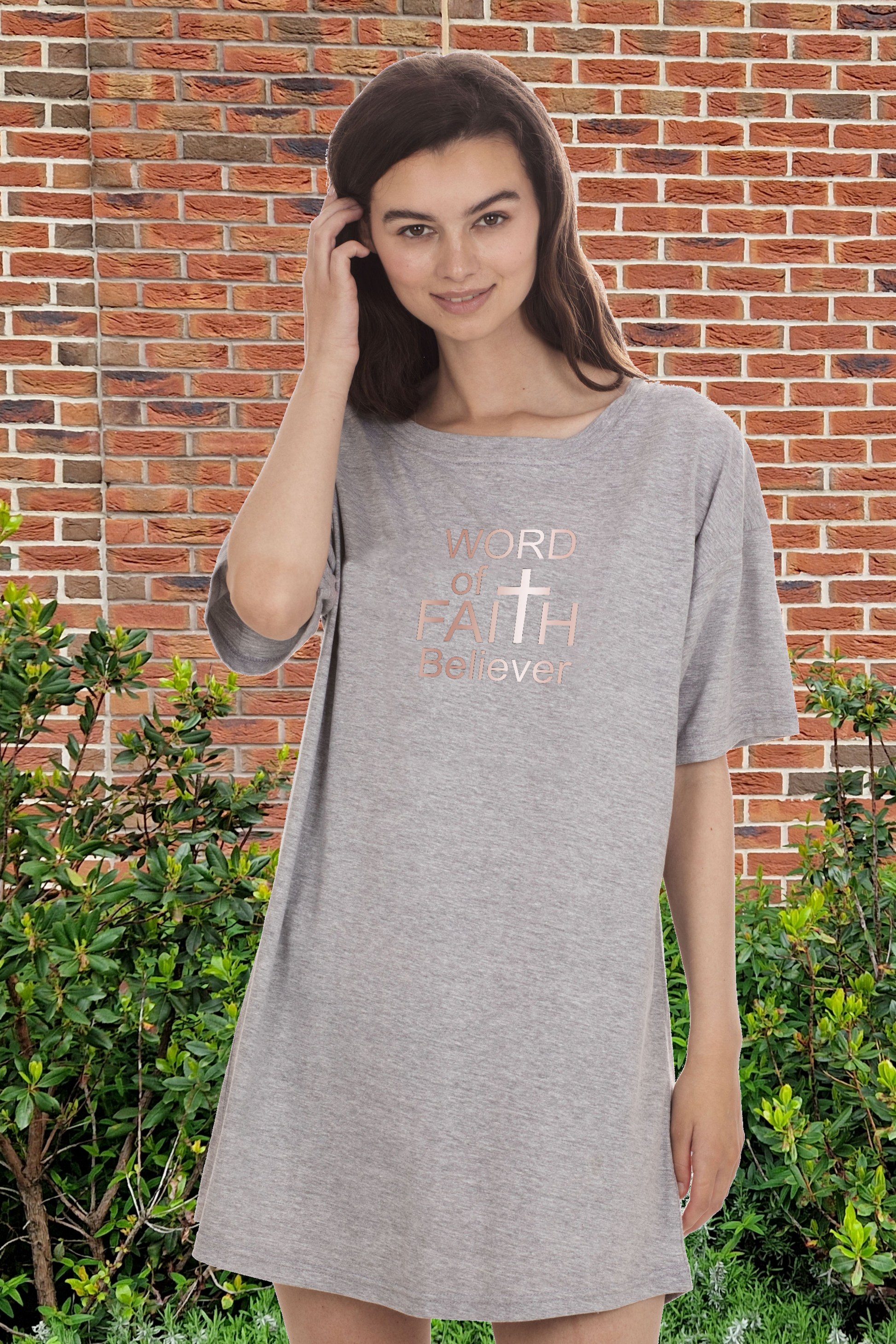 Woman wearing a grey Heavenly Dreamwear t-shirt dress with the text "Word of Faith Believer" in rose gold.