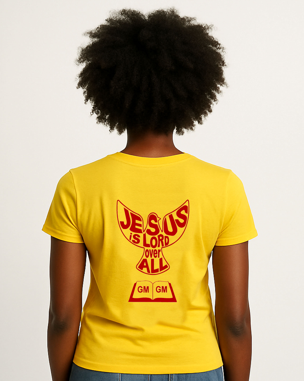 A woman wearing a yellow t-shirt with 'Jesus is Lord Over All' text on the back, standing against a plain background.