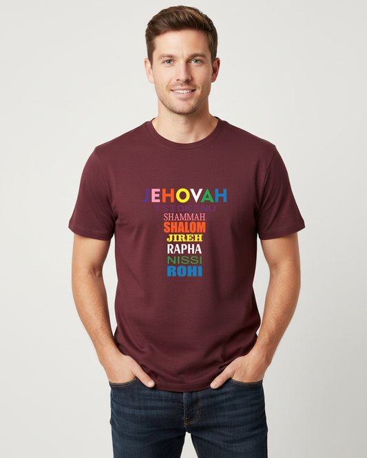 A man wearing a maroon crewneck t-shirt with a colorful text graphic on the chest, paired with dark blue jeans, standing against a light gray background.