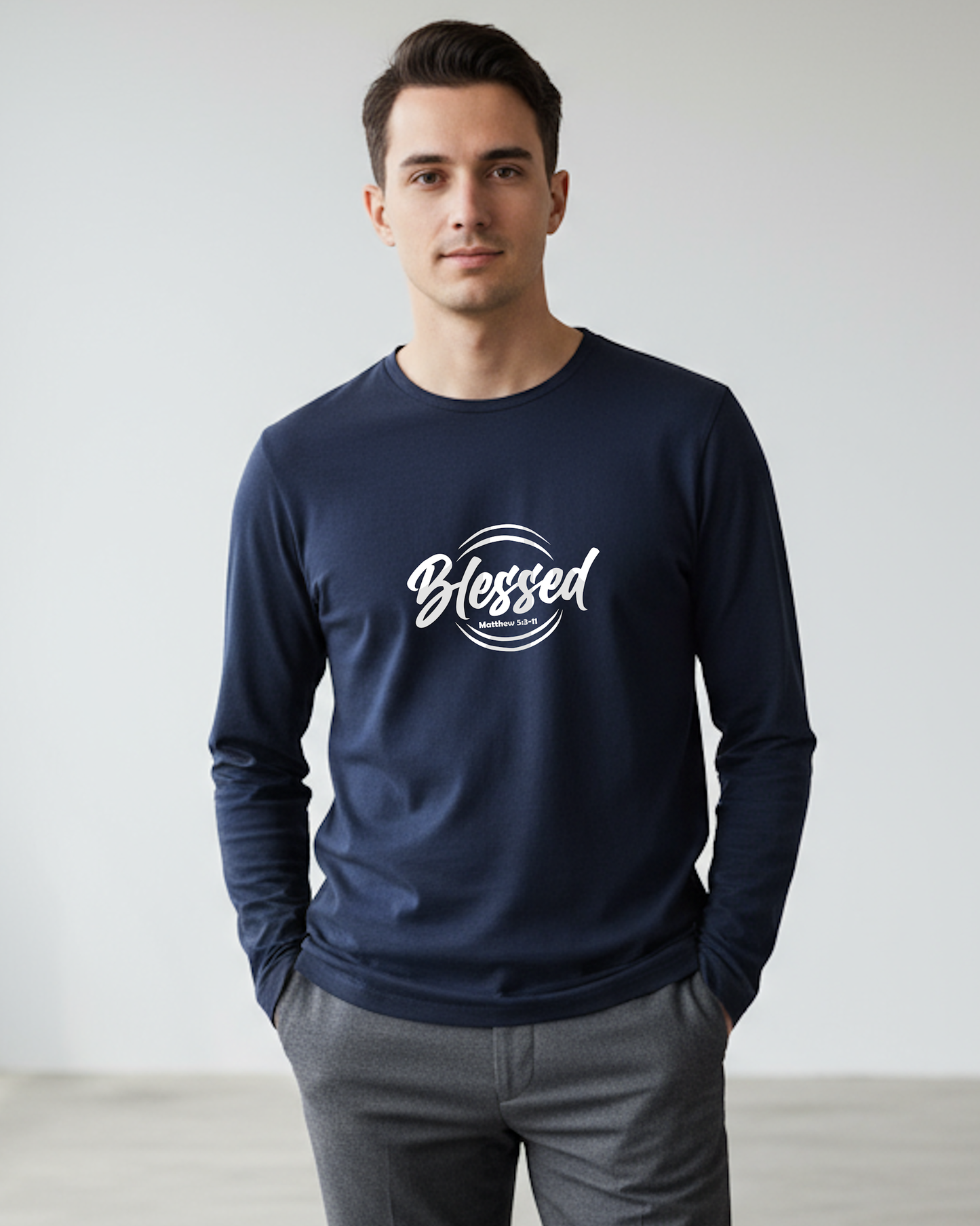 A man wearing a navy blue long sleeve T-shirt with 'Blessed' printed in white on a beige background