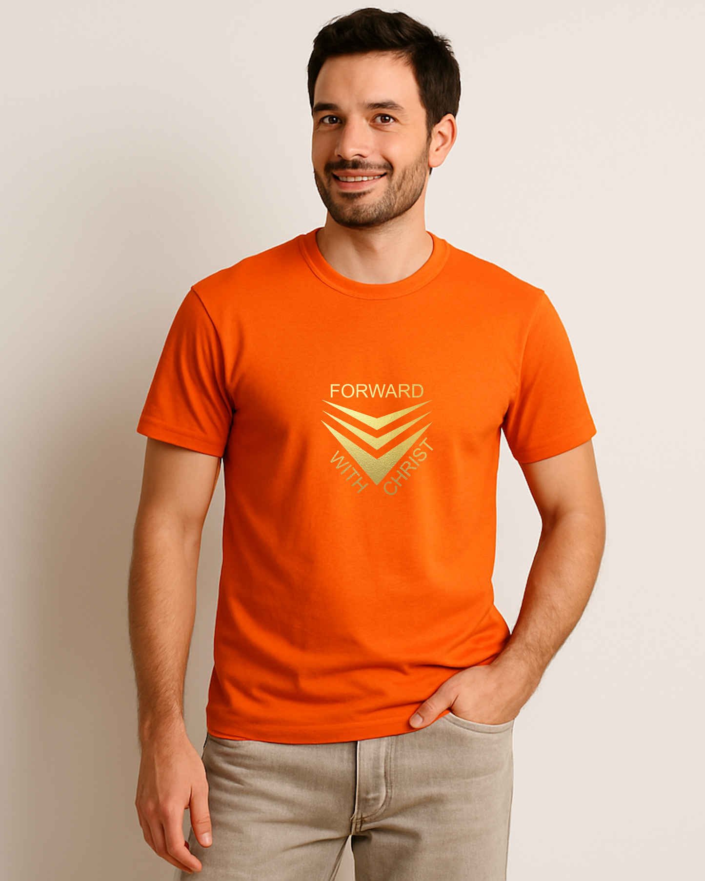 A man standing in a mall wearing an orange short sleeve t-shirt that has a gold logo with the words "FORWARD WITH CHRIST" around 3 downward pointing chevrons.