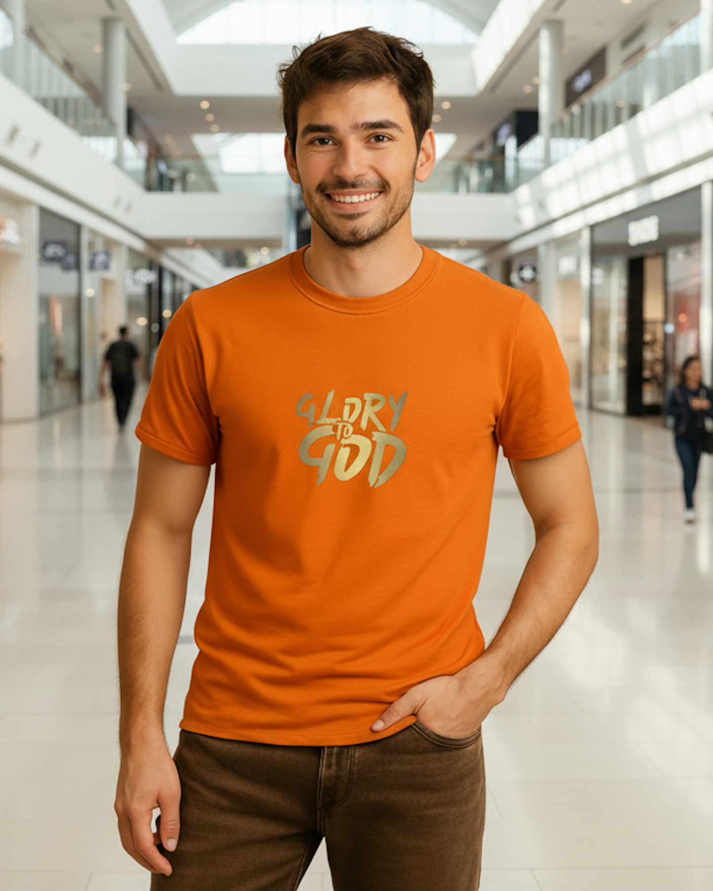 Man wearing an orange t-shirt with 'Glory to God' text in a shopping mall setting