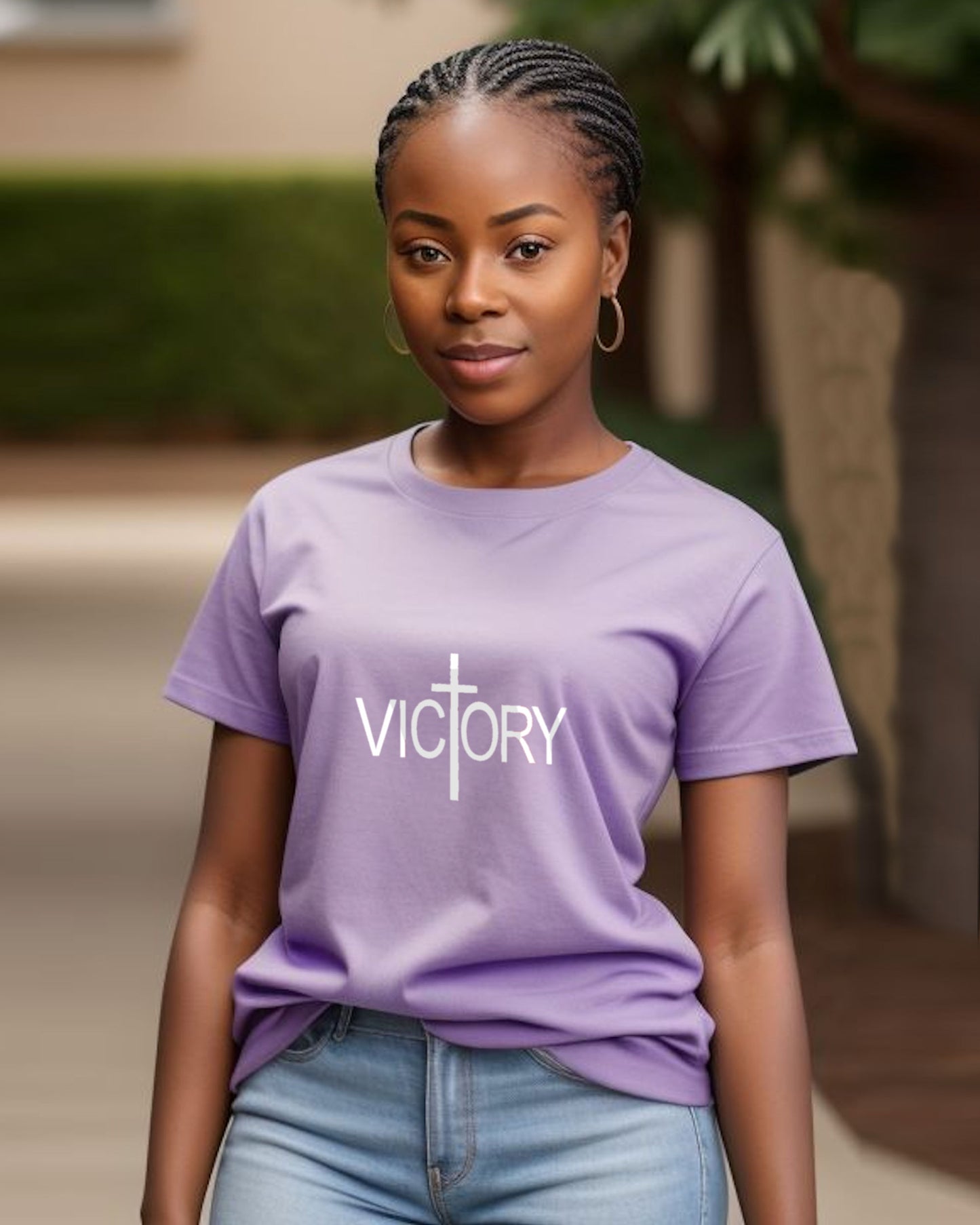 A woman wearing a purple 'VICTORY' t-shirt outdoors