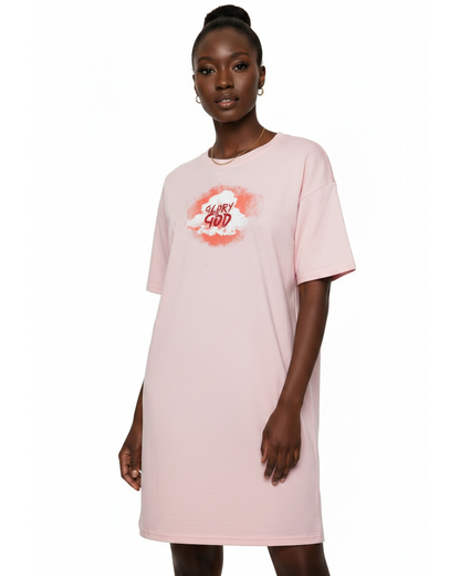 Woman wearing a light pink t-shirt dress with a graphic cloud logo printed on front against a white background