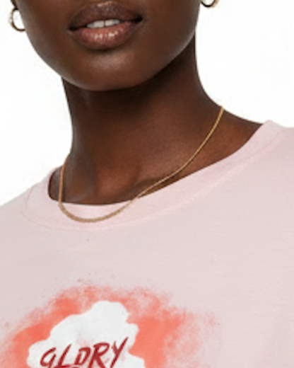 Closeup of the neckline of a woman wearing a light pink t-shirt dress