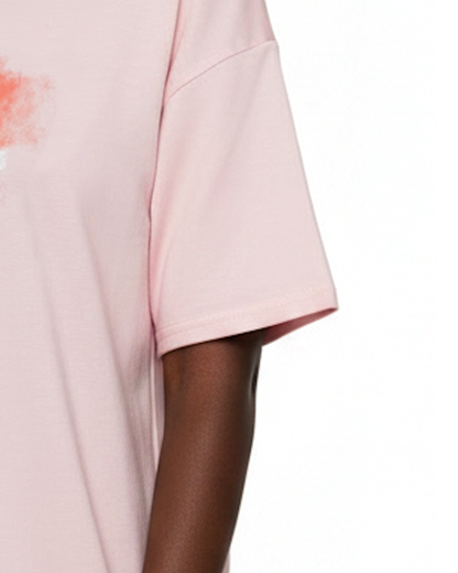 Closeup of the sleeve of a light pink t-shirt dress against a white background