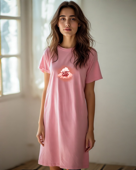 A woman in a shop wearing a pink Heavenly Dreamwear T-shirt dress with a logo containing the Text, "Glory to God" within a cloud.