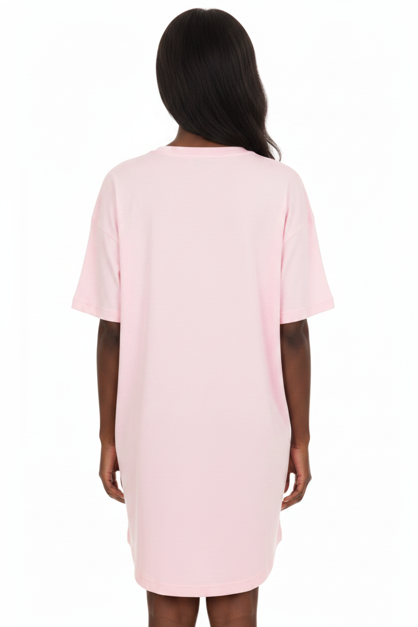 A woman wearing a light pink short-sleeve t-shirt dress shown from the back against a white background.