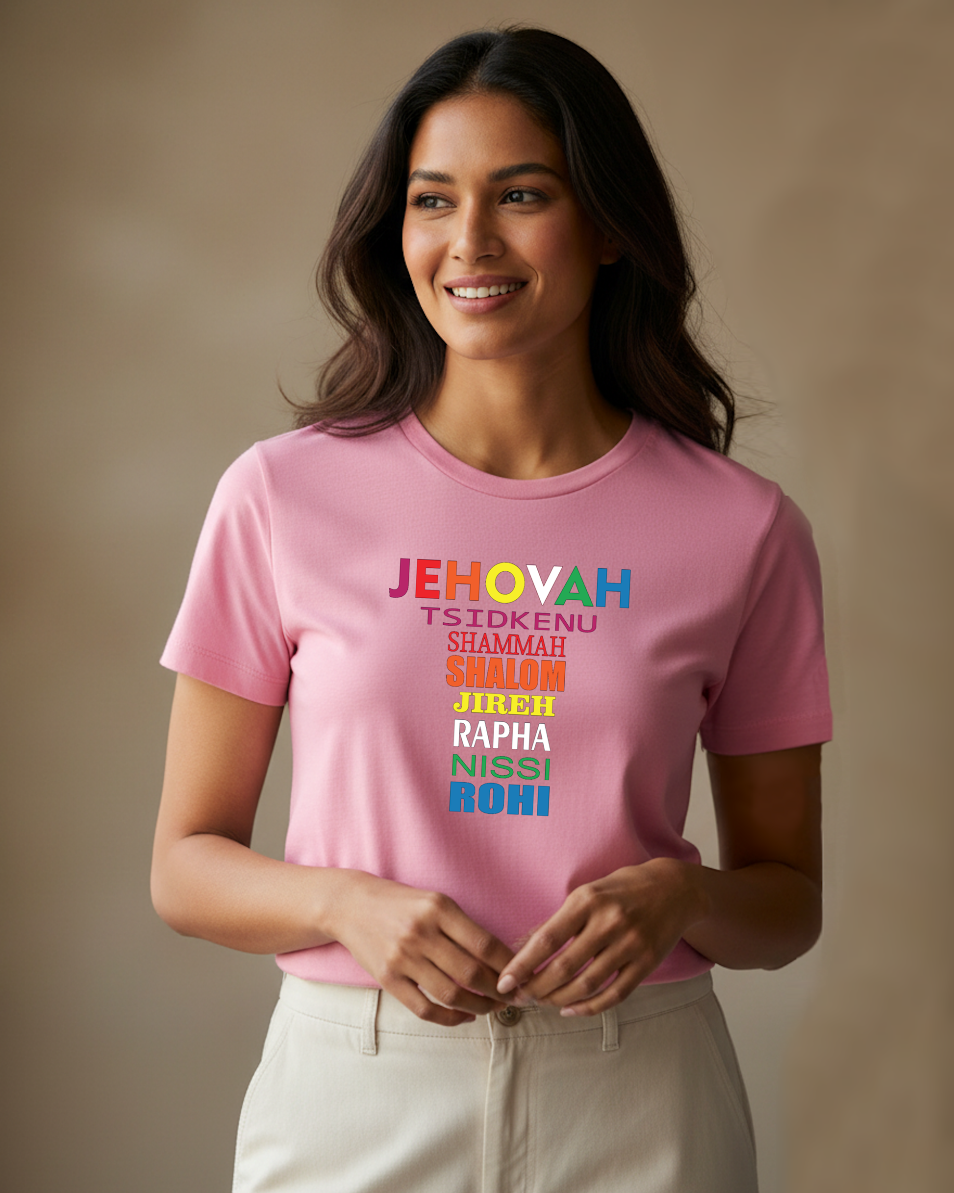 Woman wearing a pink t-shirt with colorful Hebrew text against a plain beige background