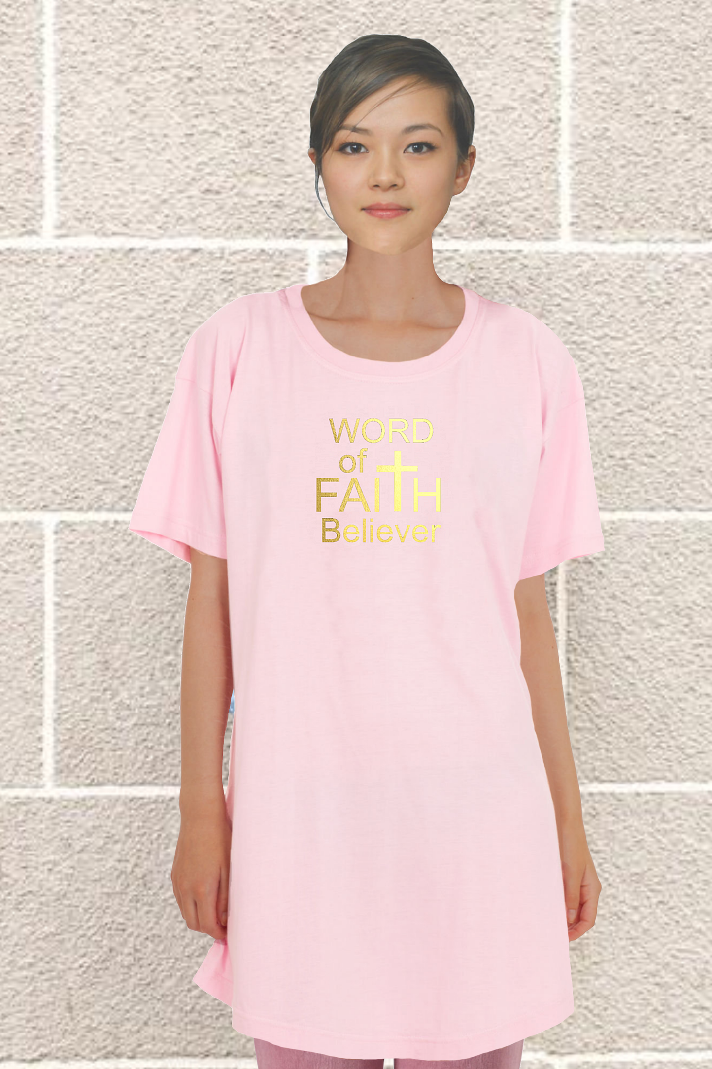 Woman wearing a pink Heavenly Dreamwear t-shirt dress with the text "Word of Faith Believer" in gold.