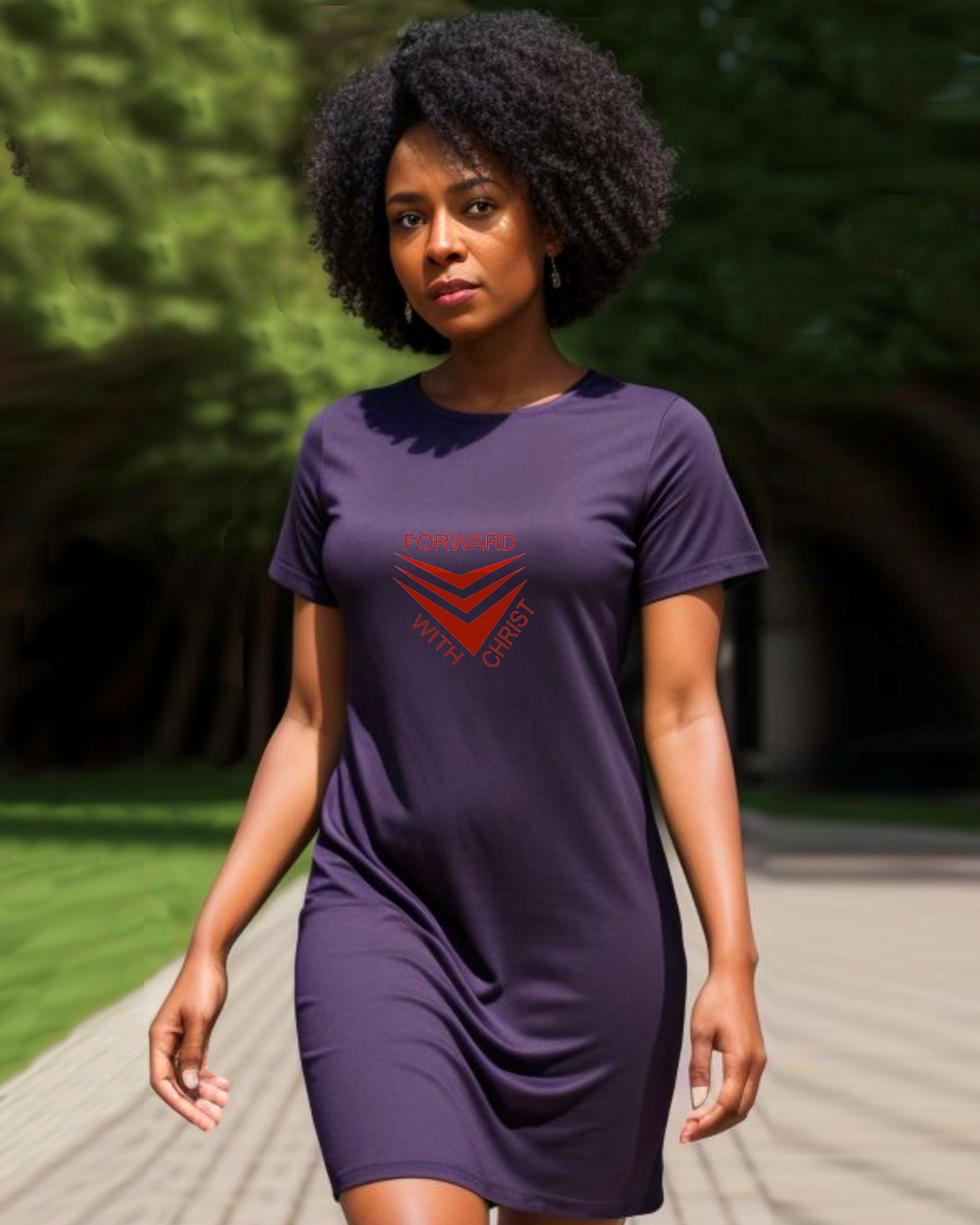 A woman walking in a sunny garden wearing a purple Heavenly Dreamwear t-shirt dress with a red logo made up of  3 chevrons surrounded by the text, "Forward With Christ".