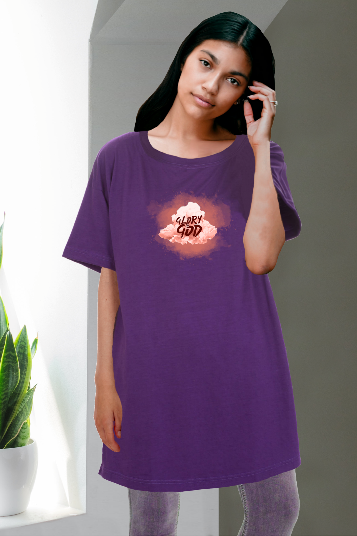 Woman wearing a purple Heavenly Dreamwear t-shirt dress with a Glory to God cloud logo.