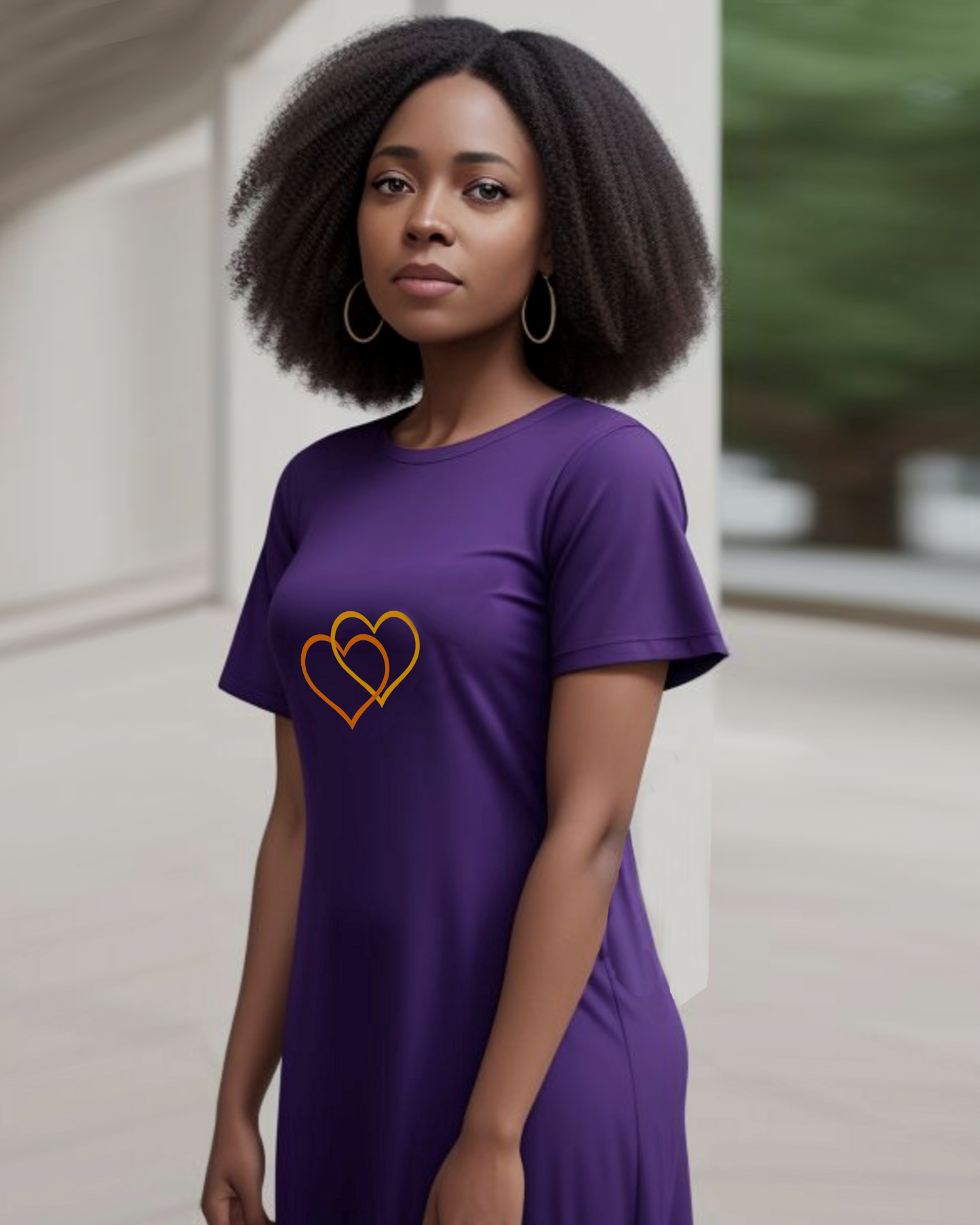 A woman dressed in a purple t-shirt dress featuring the Heavenly Dreamwear logo of two intertwined heart shapes printed on the front.