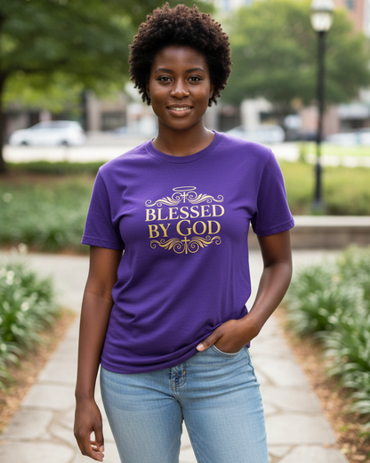 Woman wearing a purple t-shirt with gold text 'Blessed by God' printed on the front in a garden