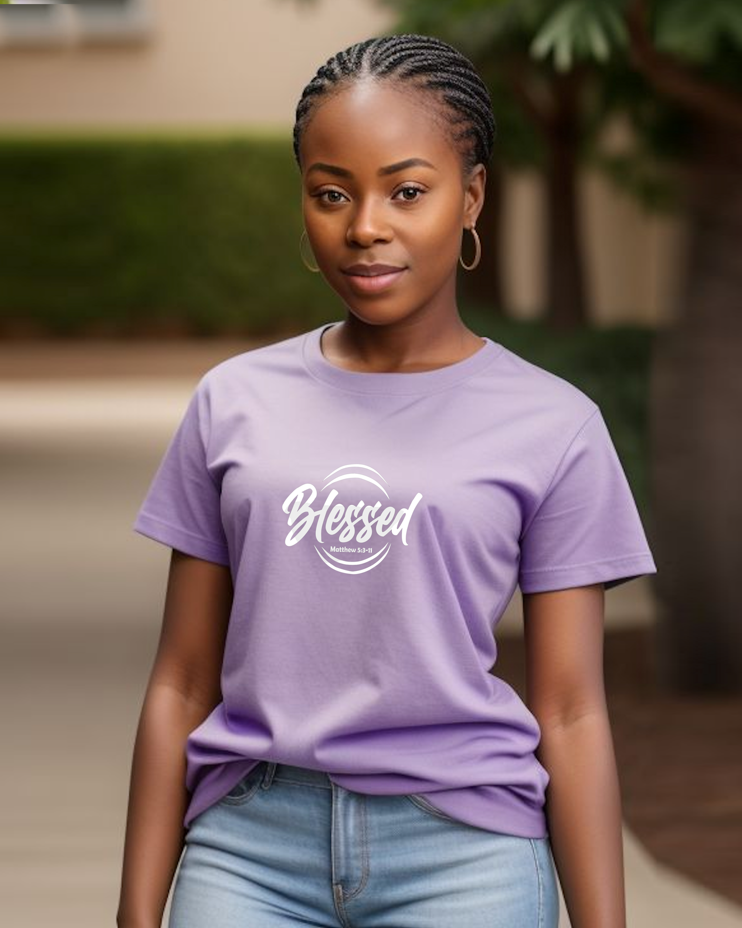 A young woman wearing a purple t-shirt with a white text logo that says 'Blessed' t-shirt in a garden.